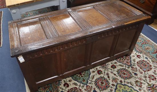 An early 18th century panelled oak coffer, with fluted frieze and moulded stiles, W.140cm